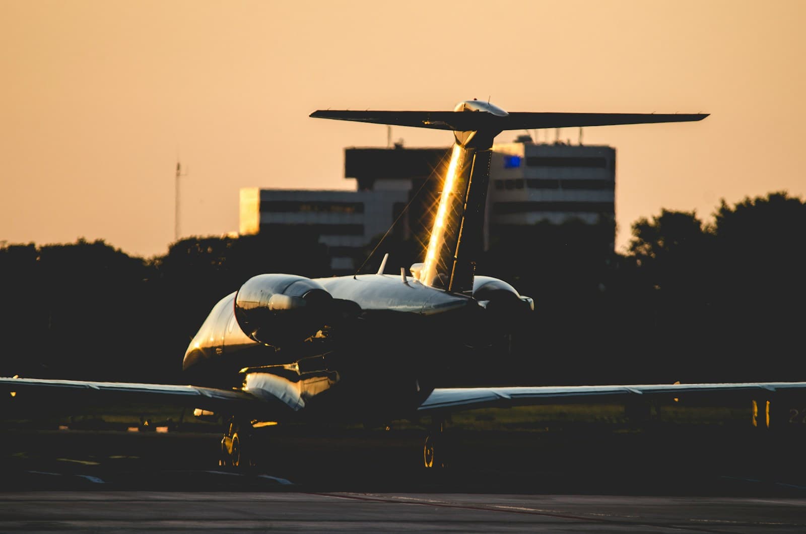 Jet privado estacionado en la pista al atardecer
